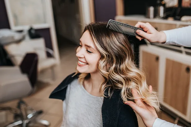 Woman getting styled hairstyle